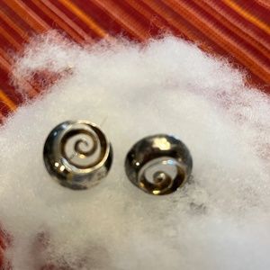 Sterling silver with 14K gold inside inner swirl